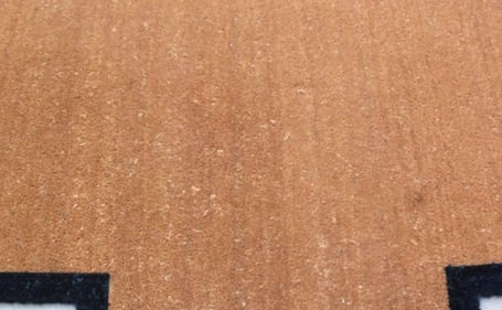 Capacho de fibra de coco para elevador enrolado, com a base preta à mostra Capacho de fibra de coco para elevador enrolado, com a base preta à mostra